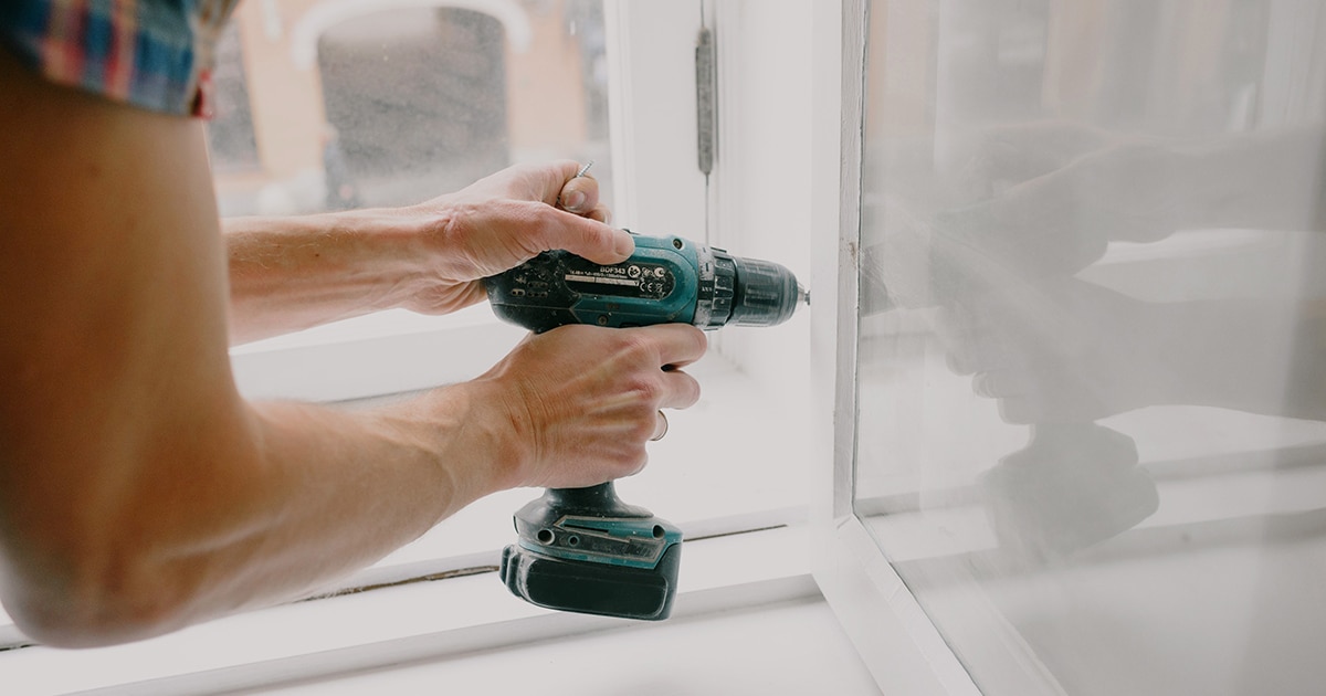 Worker using a power drill
